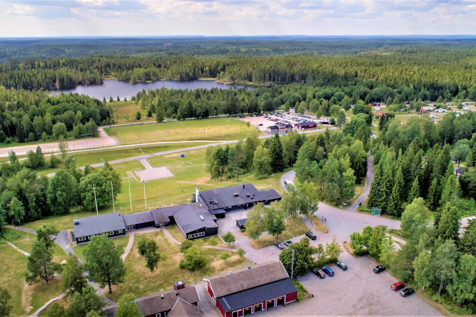First Camp Ånnaboda from above, with the cabins, the campsite and the lake in the forest